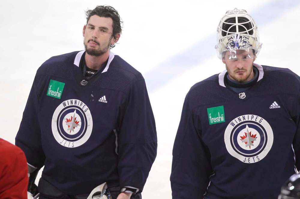 BORIS MINKEVICH / WINNIPEG FREE PRESS FILESGoalie Michael Hutchinson, right, returns to the Winnipeg Jets lineup as backup to Connor Hellebuyck.