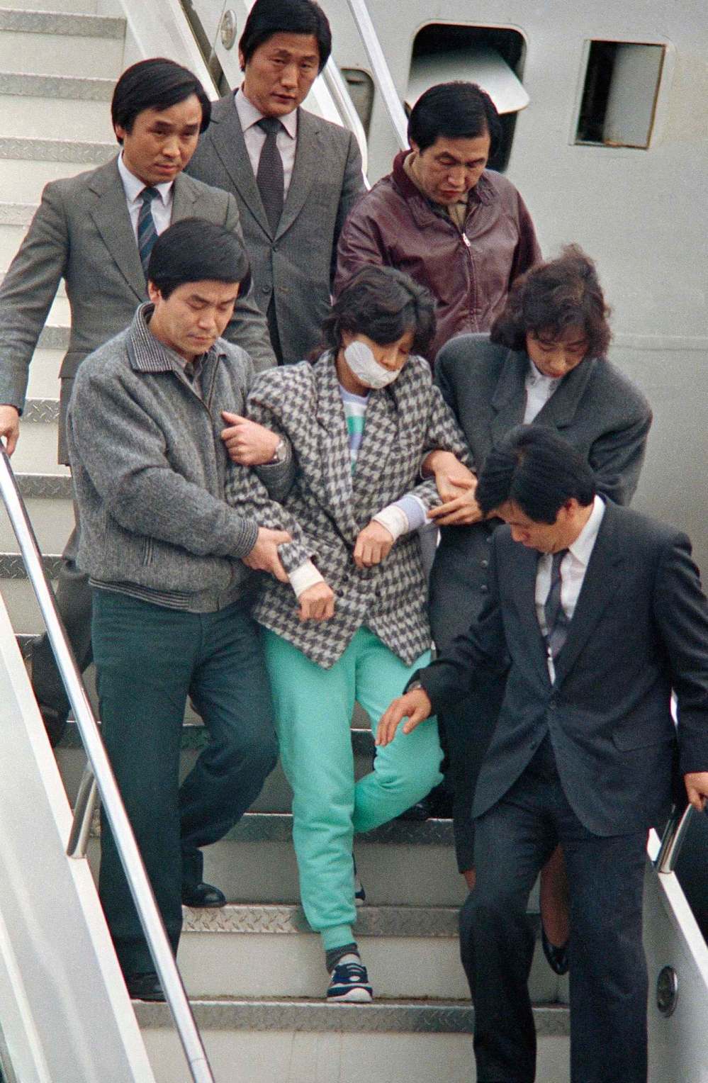 Kim Chon-kil / The Associated Press files
North Korean spy Kim Hyon-hui (centre) is escorted in 1988 after she bombed a Korean Air jetliner, which exploded off the coast of Myanmar, killing all 115 people aboard.