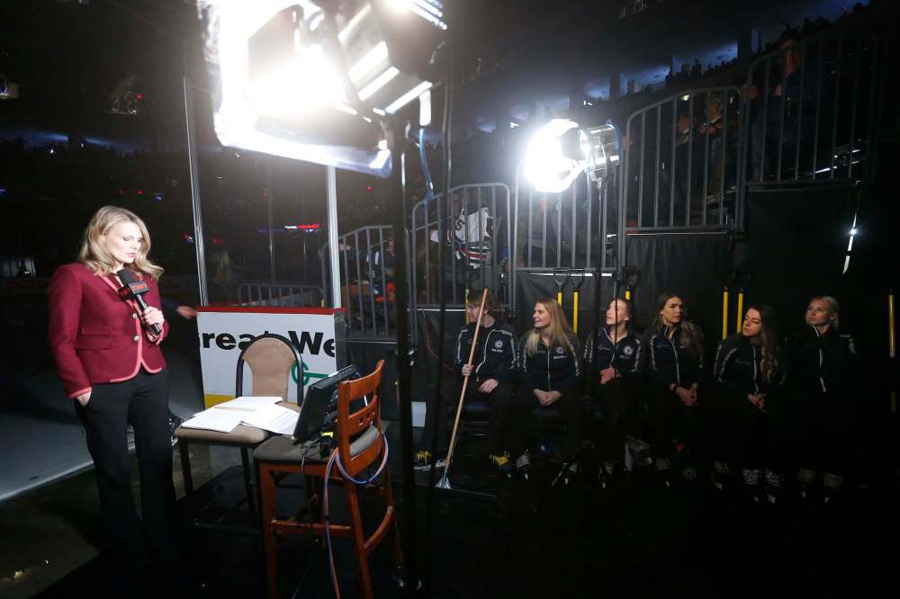 The Ice Crew sit patiently as a TV broadcast occurs prior to the first period.