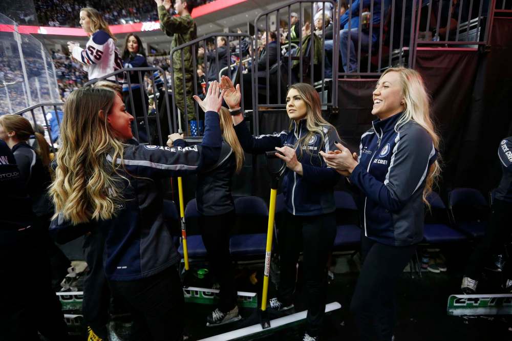 Emily Carey (from left), Casey Gall and Jen Derksen celebrate a Jets goal against the Coyotes.