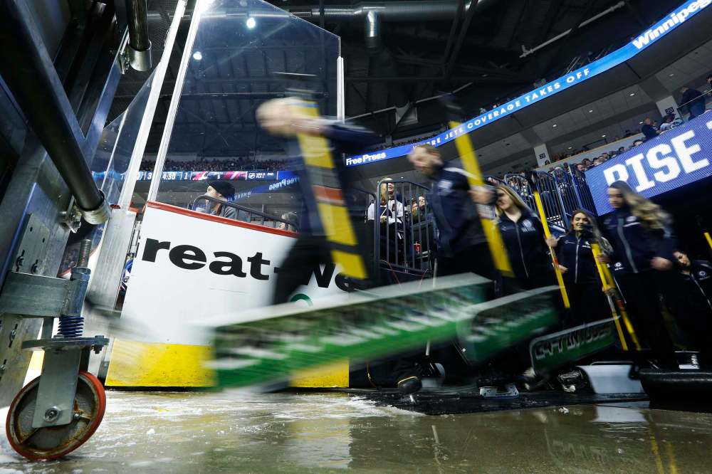 Members of the Ice Crew hit the ice during the first period.