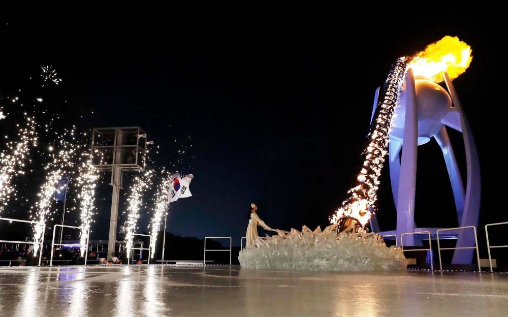 David J. Phillip,Pool / The Associated Press
South Korean Olympic figure skating champion Yuna Kim lights the Olympic flame during the opening ceremony of the 2018 Winter Olympics in Pyeongchang, South Korea on Friday.