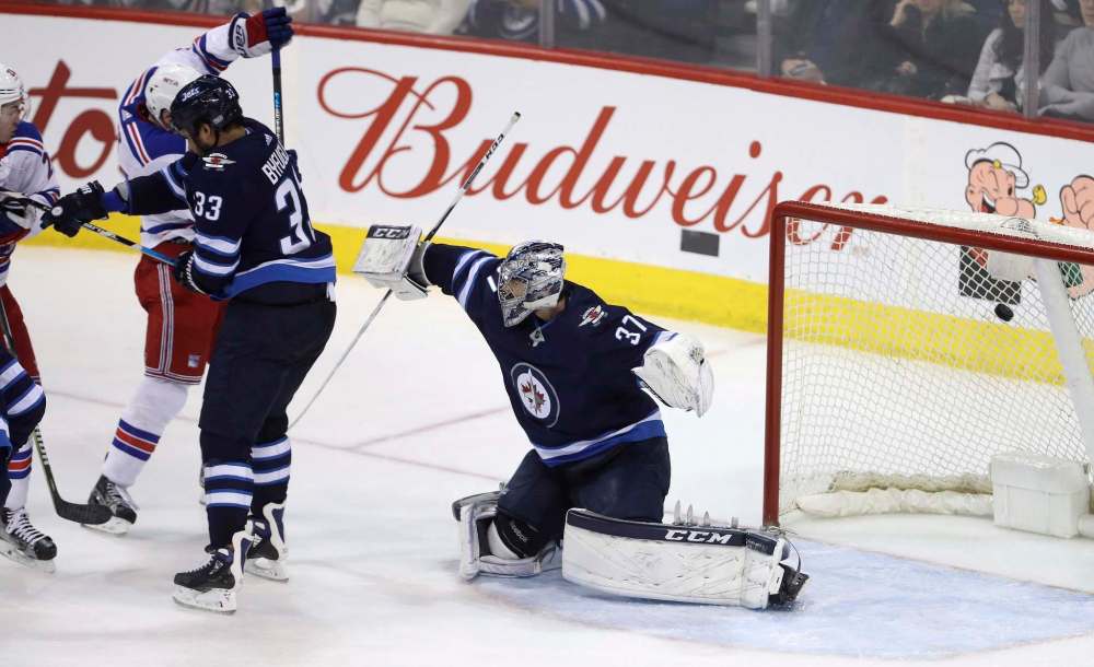 TREVOR HAGAN / THE CANADIAN PRESS
New York Rangers' Jimmy Vesey (not shown) scores on Winnipeg Jets goaltender Connor Hellebuyck (37) during third period NHL hockey action in Winnipeg, Sunday, February 11, 2018.