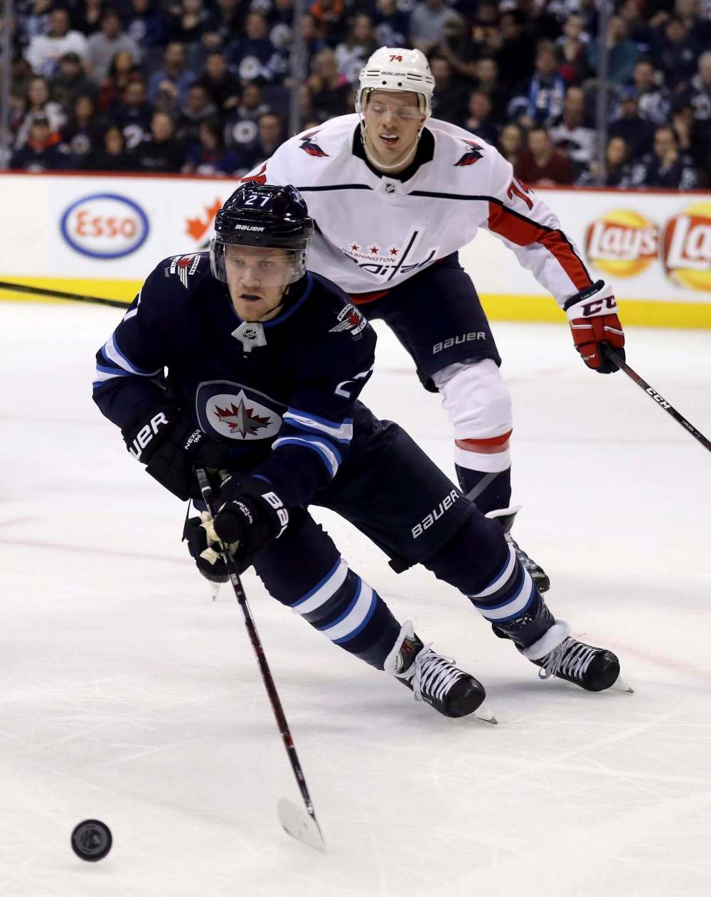THE CANADIAN PRESS/Trevor Hagan
Winnipeg Jets' Nikolaj Ehlers carries the puck in front of Washington Capitals' John Carlson during the second period in Winnipeg, Tuesday.