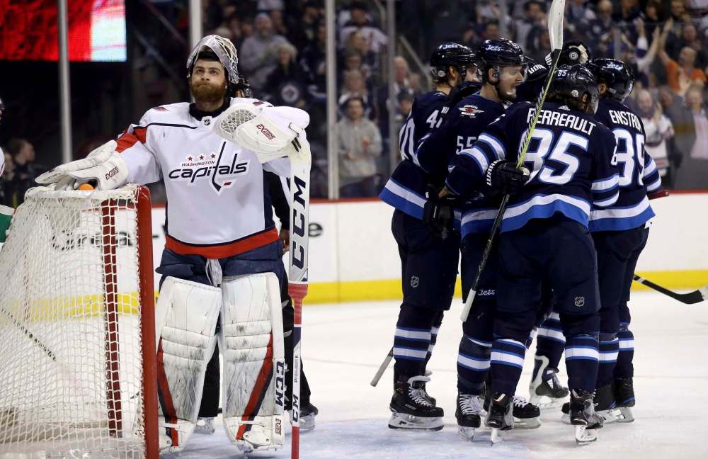 THE CANADIAN PRESS/Trevor Hagan
Winnipeg Jets players celebrate after Mark Scheifele scored on Washington Capitals' goaltender Braden Holtby during first period, Tuesday.