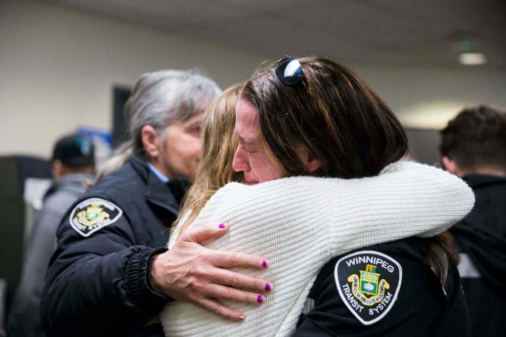 MIKAELA MACKENZIE / WINNIPEG FREE PRESS
Crystal Hanley, right, hugs Penny Teron at a memorial held by the Amalgamated Transit Union in Winnipeg for Irvine Jubal Fraser, an operator killed on the job a year ago.