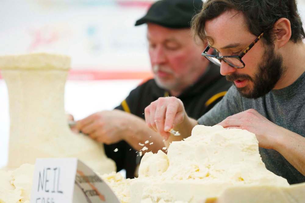 Lyle Peters (left) of Steinbach, and Neil Fogg work on their sculptures.