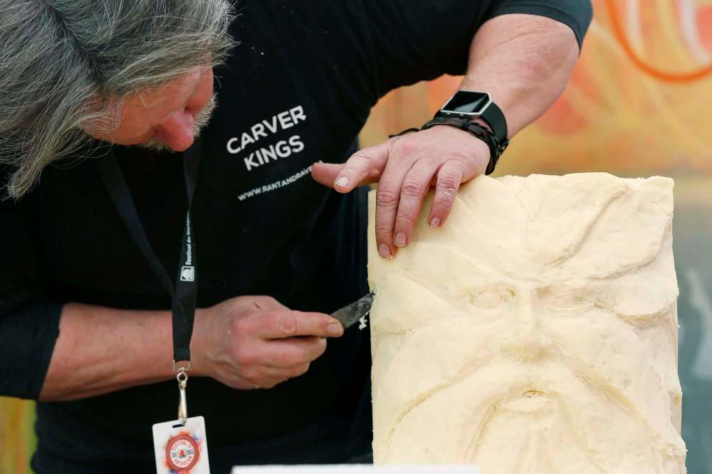 PHOTOS BY JOHN WOODS / WINNIPEG FREE PRESS
Paul Frenette from Ontario adds some touches to his sculpture during the cheese-carving competition at the Festival du Voyageur Sunday.