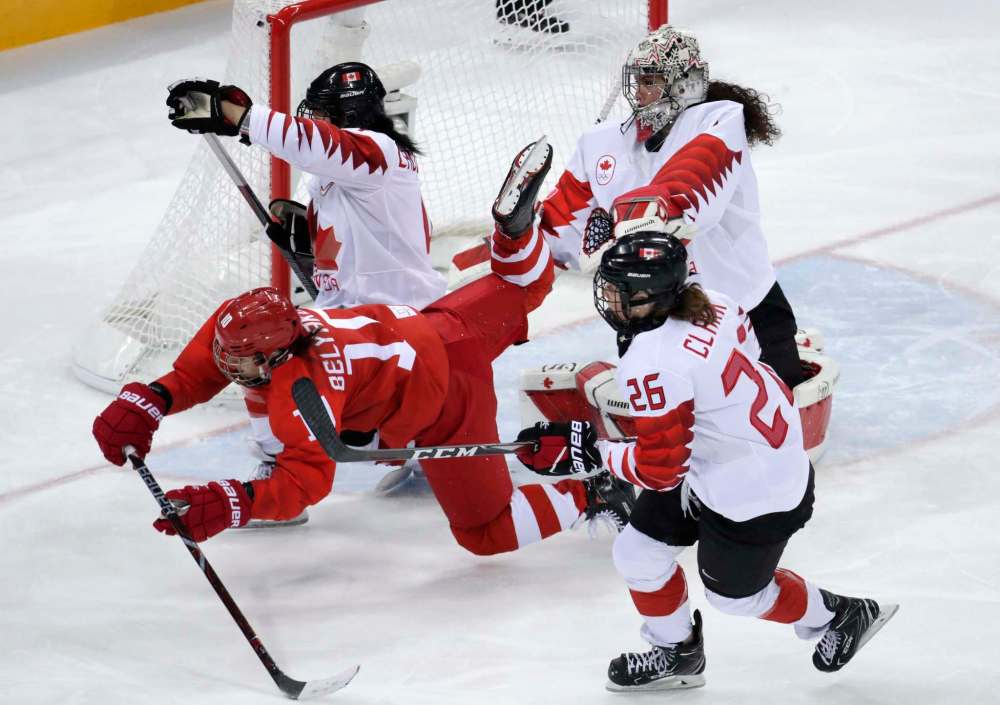 Russia's Lyudmila Belyakova collides with Brigette Lacquette (4), during the third period Monday. (Julio Cortez / The Associated Press)