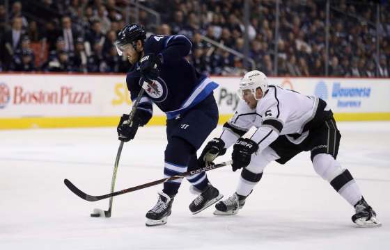 THE CANADIAN PRESS/Trevor HaganWinnipeg Jets' Joel Armia fires a shot in front of Los Angeles Kings' Christian Folin during first period NHL hockey action in Winnipeg, Tuesday.