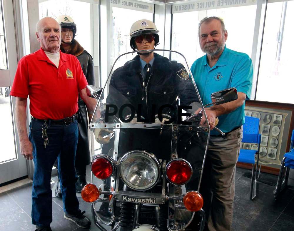 BORIS MINKEVICH / WINNIPEG FREE PRESS
The Winnipeg Police Museum at the new Police Headquarters. From left, Police historians Jack Templeman and Randy James with an old police motorcycle.