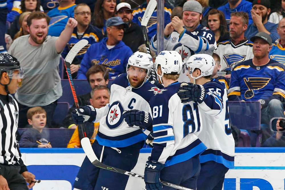 (AP Photo/Billy Hurst)
Winnipeg Jets' Blake Wheeler, left, is congratulated by Kyle Connor and Mark Scheifele, right, after scoring a goal against the St. Louis Blues during the first period of an NHL hockey game Friday, Feb. 23, 2018, in St. Louis.