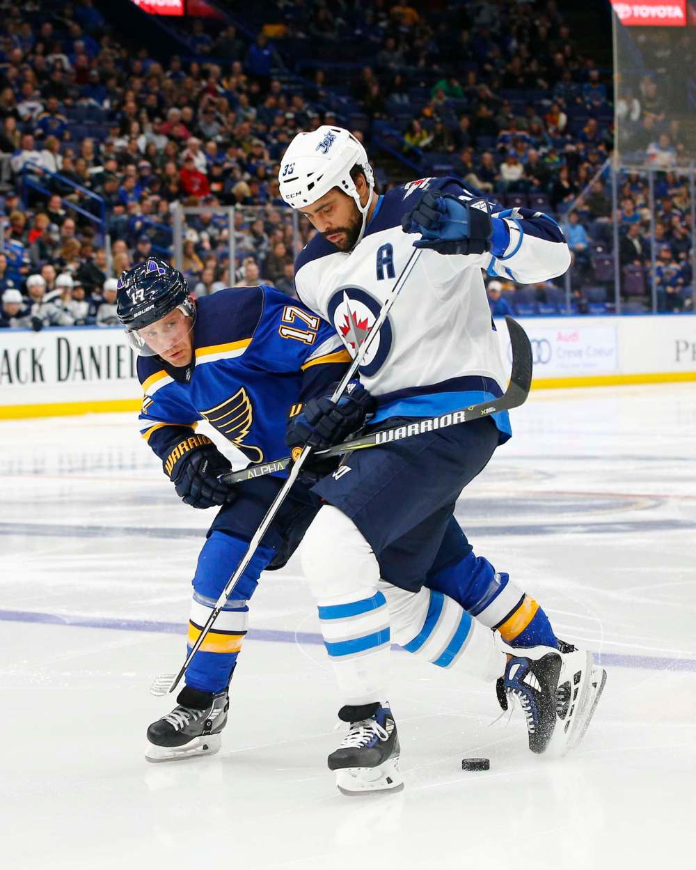 (AP Photo/Billy Hurst)
St. Louis Blues' Jaden Schwartz, left, and Winnipeg Jets' Dustin Byfuglien battle for the puck during the second period of an NHL hockey game Friday, Feb. 23, 2018, in St. Louis.