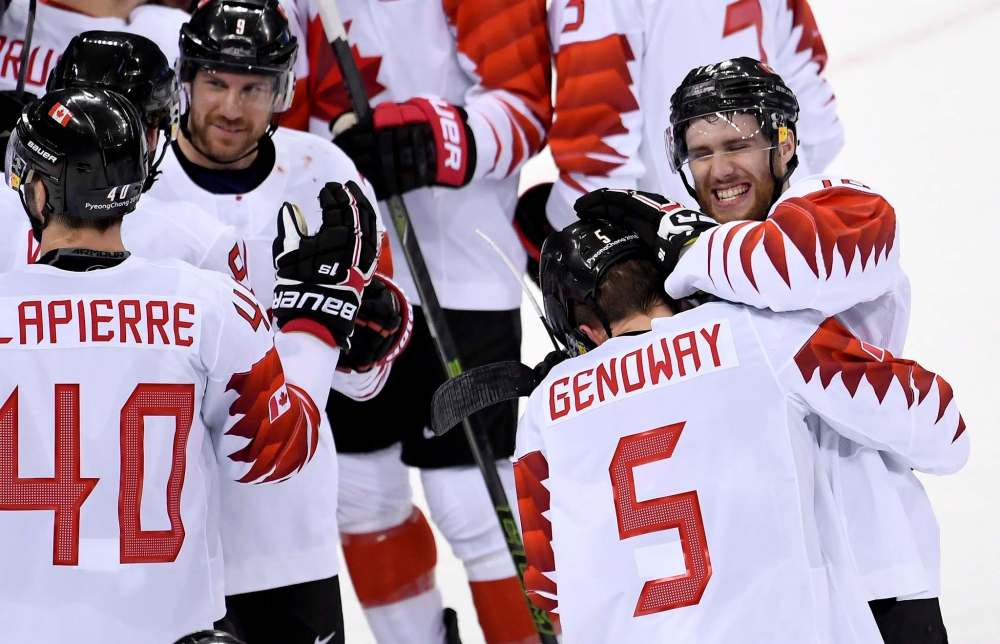 Quinton Howden (16) celebrates with Chay Genoway (5) on their win in the men's hockey bronze medal game action against Czech Republic Saturday. (Nathan Denette / The Canadian Press)