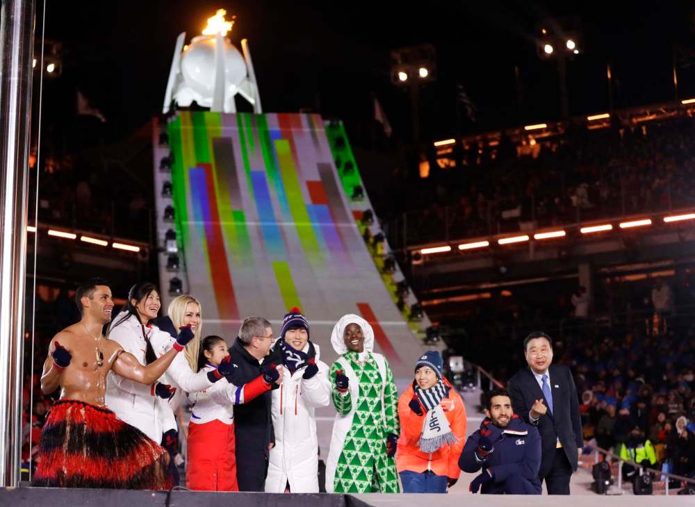 Kirsty Wigglesworth / The Associated Press
Athletes from various nations including Pita Taufatofua, of Tonga, at left, United States' Lindsey Vonn, third from left, and Thomas Bach, president of the International Olympic Committee, fifth from left, pose during the closing ceremony of the 2018 Winter Olympics in Pyeongchang, South Korea, Sunday, Feb. 25, 2018.