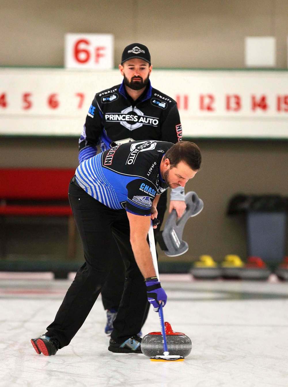 PHIL HOSSACK / WINNIPEG FREE PRESS - TEAM CARRUTHERS - Ried Carruthers watches team mate Derek Samagalski sweep down ice during a practice session at the Granit CC Tuesday afternoon. See Jay Bell's story. - February 27, 2018