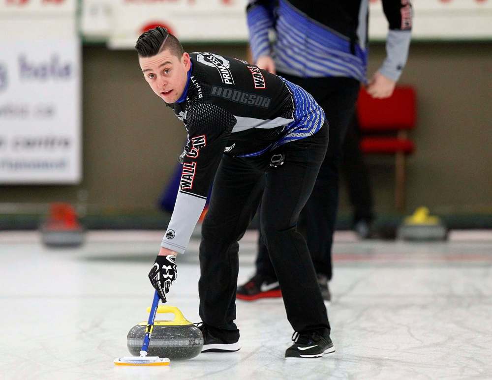 PHIL HOSSACK / WINNIPEG FREE PRESS - TEAM CARRUTHERS - Carruthers lead, Colin Hodgson sweeps down ice during a practice session at the Granit CC Tuesday afternoon. See Jay Bell's story. - February 27, 2018