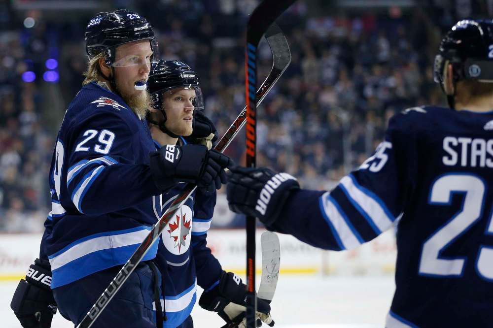 THE CANADIAN PRESS/John Woods
Winnipeg Jets' Patrik Laine celebrates his goal with teammates Nikolaj Ehlers and Paul Stastny during second period NHL action against the Detroit Red Wings, in Winnipeg on Friday.