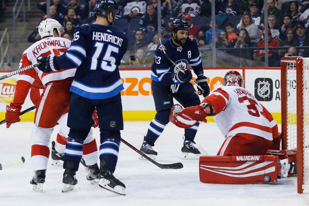THE CANADIAN PRESS/John Woods
Winnipeg Jets' Dustin Byfuglien scores on Detroit Red Wings Jimmy Howard as Jets' Matt Hendricks and Red Wings' Niklas Kronwall look on during second period Friday.