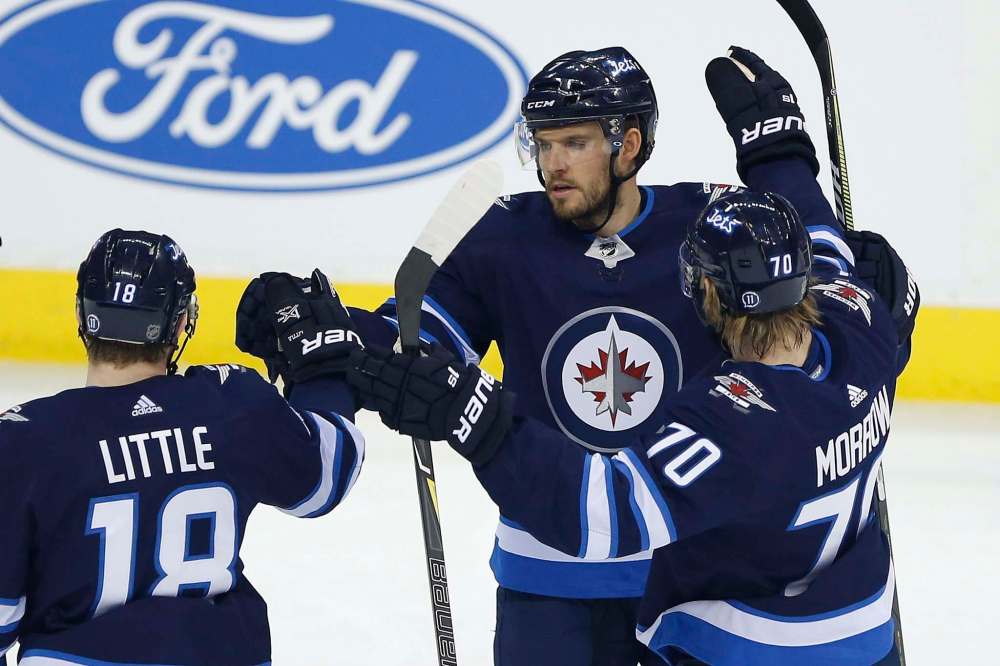 THE CANADIAN PRESS/John Woods
Winnipeg Jets' Ben Chiarot celebrates his goal against the Detroit Red Wings with teammates Bryan Little and Joe Morrow during first period Friday.