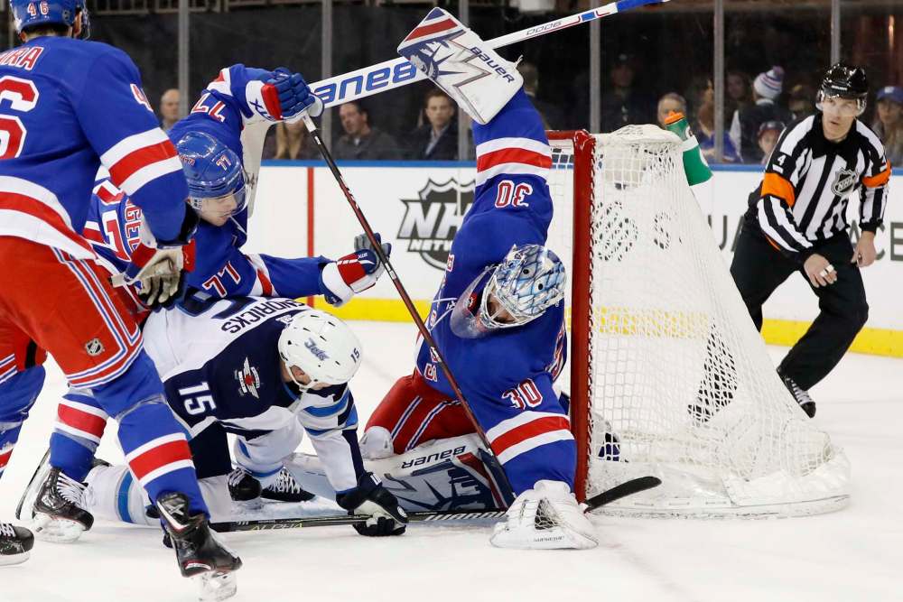 (AP Photo/Kathy Willens)
New York Rangers defenseman Tony DeAngelo (77) defends as Rangers goaltender Henrik Lundqvist (30) of Sweden makes a save with Winnipeg Jets center Matt Hendricks (15) has his stick caught in the middle trying to score for the Jets during the first period of an NHL hockey game in New York, Tuesday, March 6, 2018.