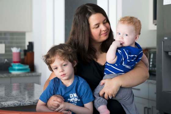 MIKAELA MACKENZIE / WINNIPEG FREE PRESSJamie Streilein and her sons Keaton, 3, and Elliot, 9 months, at their home in Sage Creek on Sunday. The Streilein family, as well as others in the subdivision, must show proof of residency to be eligible for placement at the school.