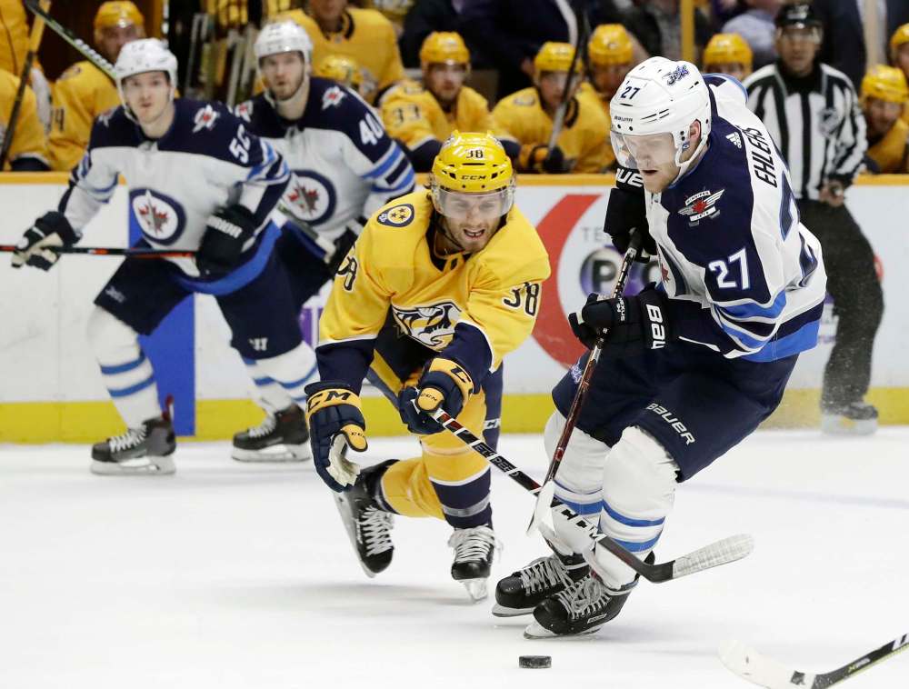 AP Photo/Mark Humphrey
Winnipeg Jets left wing Nikolaj Ehlers moves the puck against Nashville Predators right wing Ryan Hartman in the first period Tuesday in Nashville.