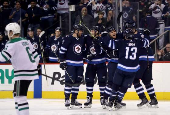 TREVOR HAGAN / THE CANADIAN PRESSWinnipeg Jets' Adam Lowry (17), Joel Armia (40), Ben Chiarot (7), Brandon Tanev (13) and Tyler Myers (57) celebrate after Chiarot scored during second period NHL hockey action against the Dallas Stars, in Winnipeg, Sunday, March 18, 2018.