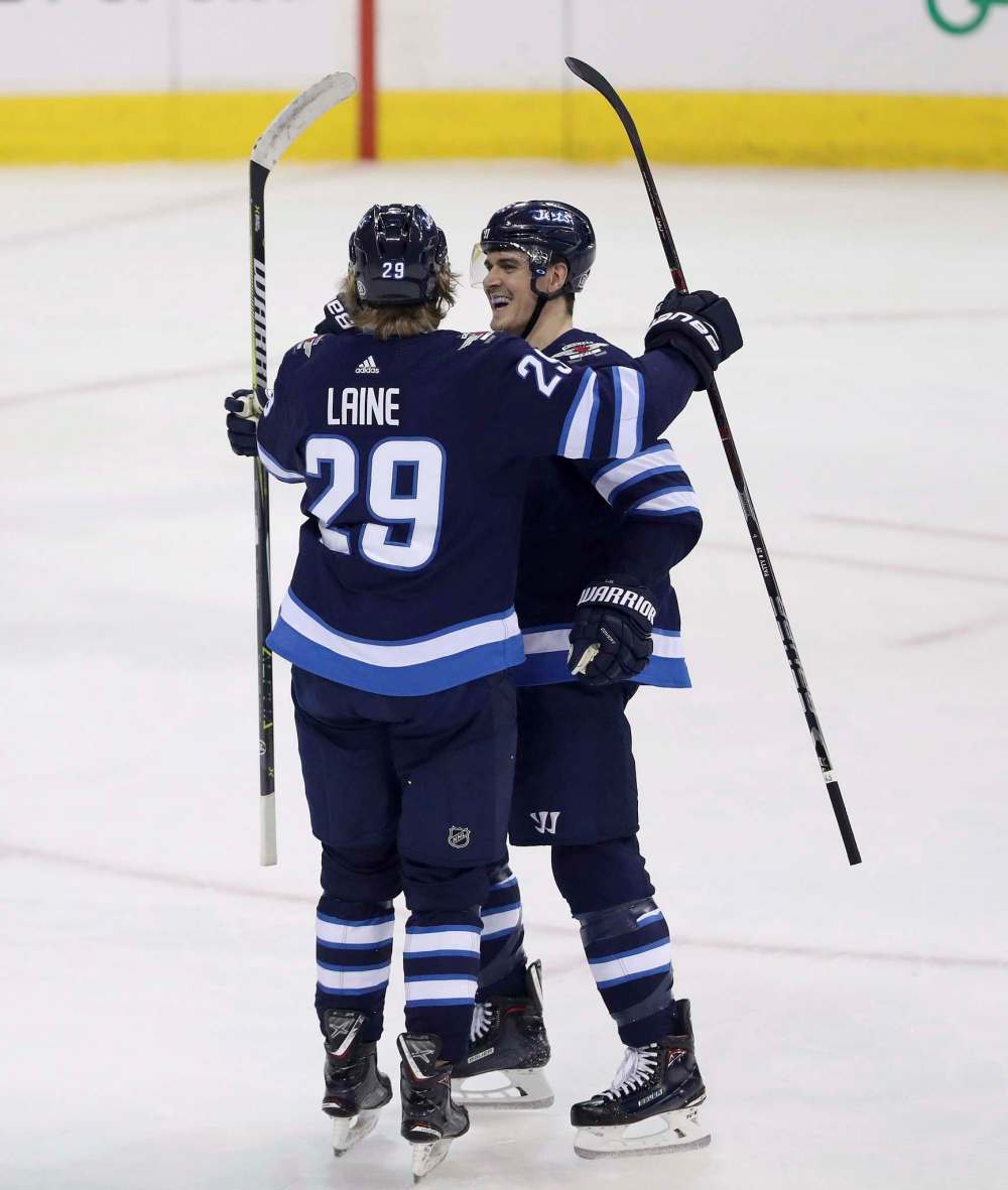 TREVOR HAGAN / THE CANADIAN PRESS
Winnipeg Jets' Patrik Laine (29) celebrates with Mark Scheifele (55) after he scored against the Dallas Stars during first period NHL hockey action in Winnipeg, Sunday, March 18, 2018.