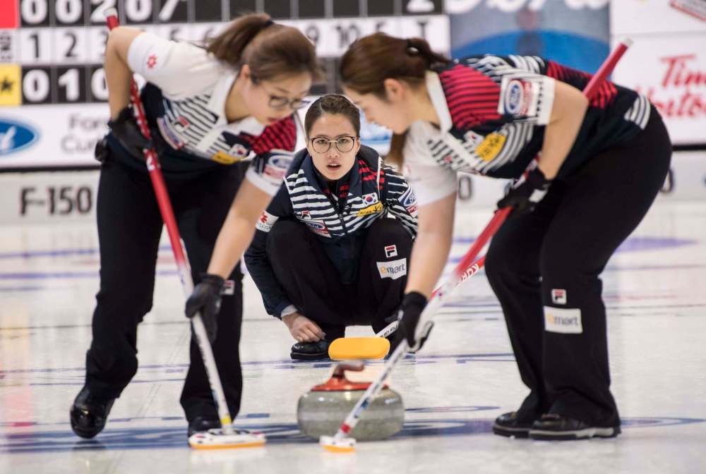 THE CANADIAN PRESS/Paul Chiasson
South Korea skip Kim Eunjung watches her stone as Kim YeongMi, right, and Kim Seon Yeong sweep during the World Women's Curling Championship in North Bay, Ont.