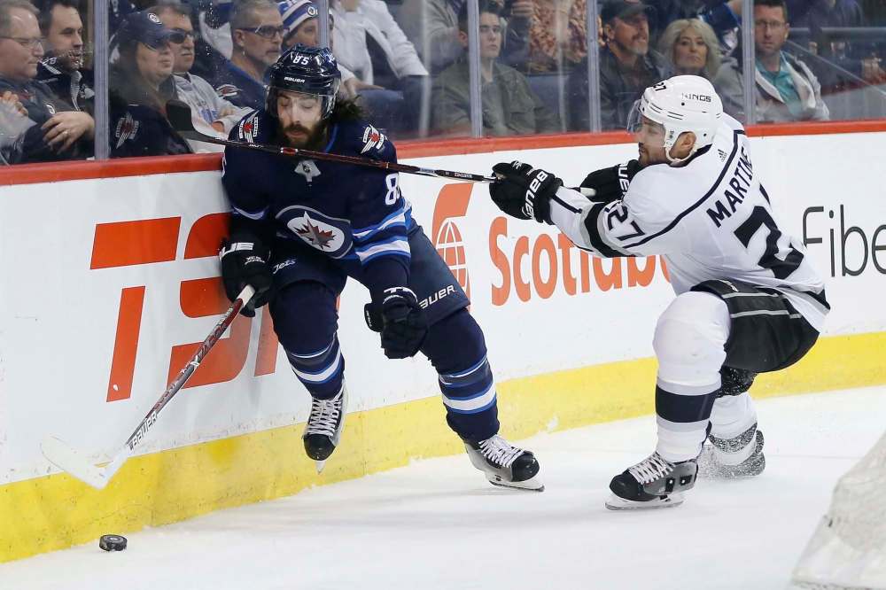 John Woods / The Canadian Press files
Jets forward Mathieu Perreault (left) hustles the puck past L.A. Kings defenceman Alex Martinez on Tuesday. Perreault is confident he’ll regain his scoring touch.