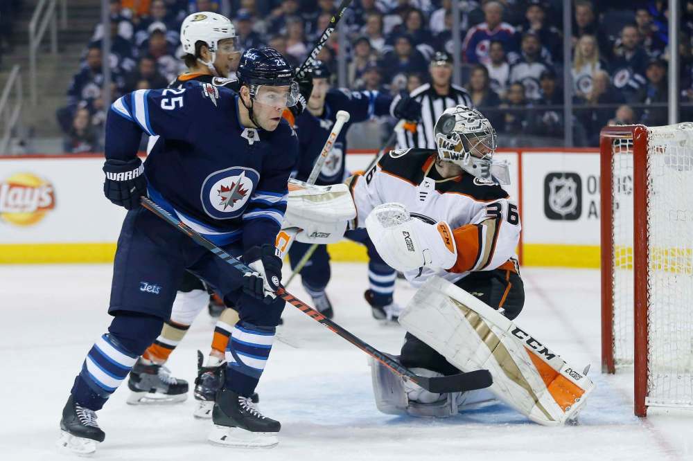 THE CANADIAN PRESS/John Woods
Anaheim Ducks goaltender John Gibson loses track of the puck as it bounces off the boards and Winnipeg Jets centre Paul Stastny attempts to smack it in during second period NHL action in Winnipeg on Friday.