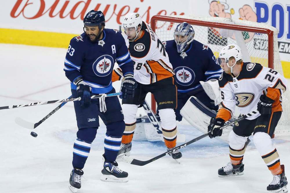THE CANADIAN PRESS/John Woods
Anaheim Ducks centre Derek Grant tips the puck past Winnipeg Jets goaltender Connor Hellebuyck for a goal as defenceman Dustin Byfuglien and Ducks right wing Ondrej Kase look on during the first period.