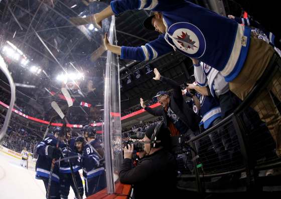 TREVOR HAGAN / THE CANADIAN PRESSWinnipeg Jets' Josh Morrissey (44), Ben Chiarot (7), Bryan Little (18) and Kyle Connor (81) celebrate after Little scored as Jets fans go crazy as the team played against the Nashville Predators' during second period NHL hockey action in Winnipeg, Sunday, March 25, 2018. Image created with a fisheye lens.