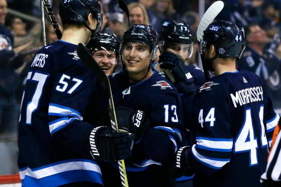 Winnipeg Jets' Brandon Tanev (13) celebrates his second goal of the game against the Boston Bruins during second period NHL action in Winnipeg on Tuesday, March 27, 2018. THE CANADIAN PRESS/John Woods