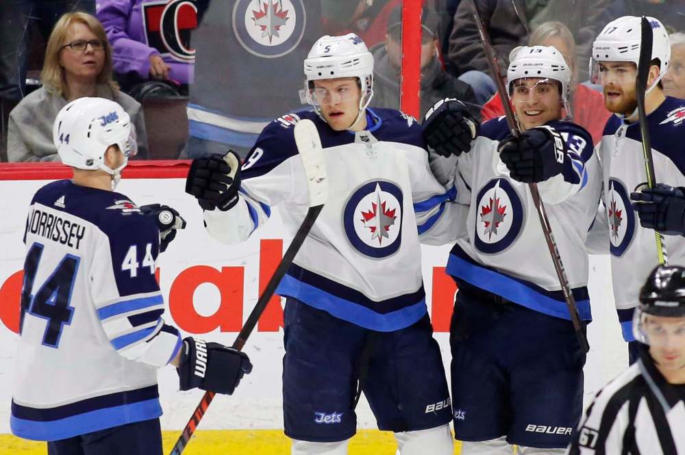 THE CANADIAN PRESS/ Patrick Doyle
Winnipeg Jets Andrew Copp (9) celebrates his goal with teammates Josh Morrissey (44), Brandon Tanev (13) and Adam Lowry (17) during first period NHL hockey action against the Ottawa Senators at the Canadian Tire Centre in Ottawa on Monday.