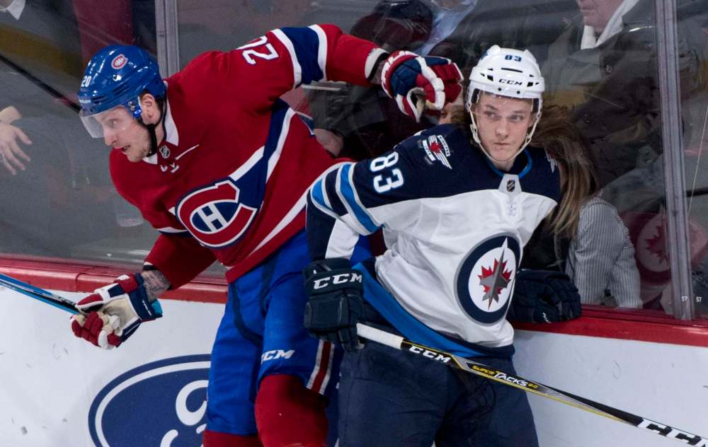 THE CANADIAN PRESS/Paul Chiasson
Winnipeg Jets' Sami Niku avoids a check by Montreal Canadiens' Nicolas Deslauriers during second period NHL hockey action Tuesday, in Montreal.