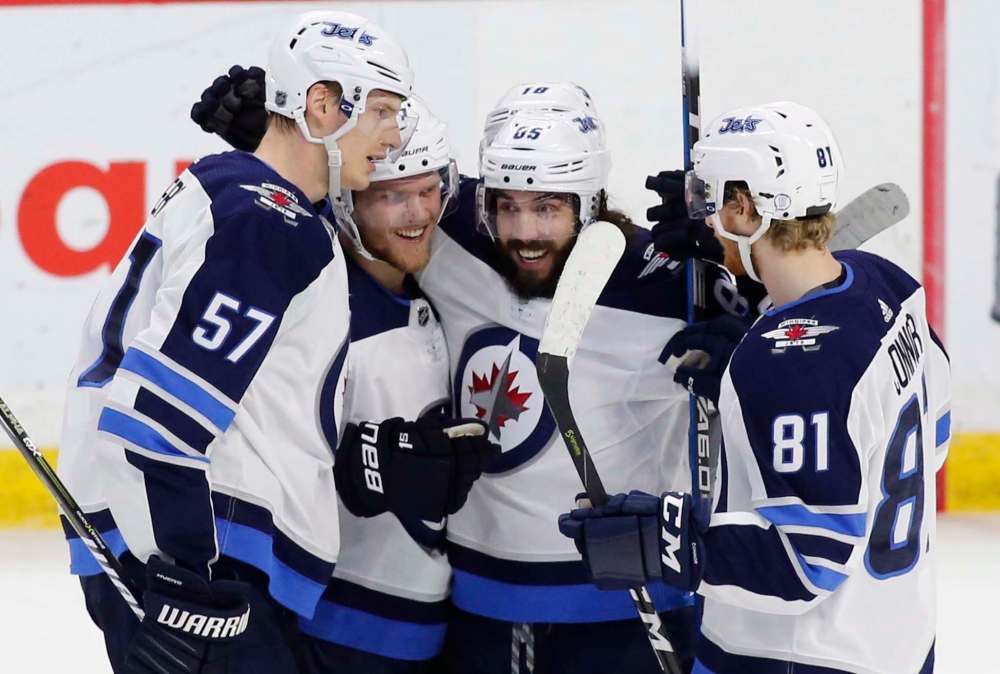 THE CANADIAN PRESS / Patrick Doyle
Winnipeg Jets players celebrate their game winning goal against the Ottawa Senators at the Canadian Tire Centre in Ottawa on Monday. The Jets returned to Winnipeg Wednesday after a raucous road trip that saw them win three out of four games.