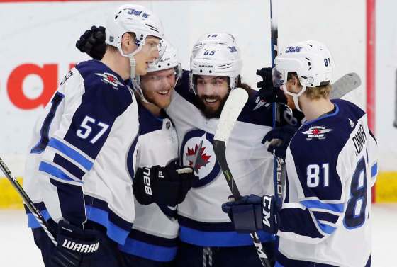 THE CANADIAN PRESS / Patrick DoyleWinnipeg Jets players celebrate their game winning goal against the Ottawa Senators at the Canadian Tire Centre in Ottawa on Monday. The Jets returned to Winnipeg Wednesday after a raucous road trip that saw them win three out of four games.