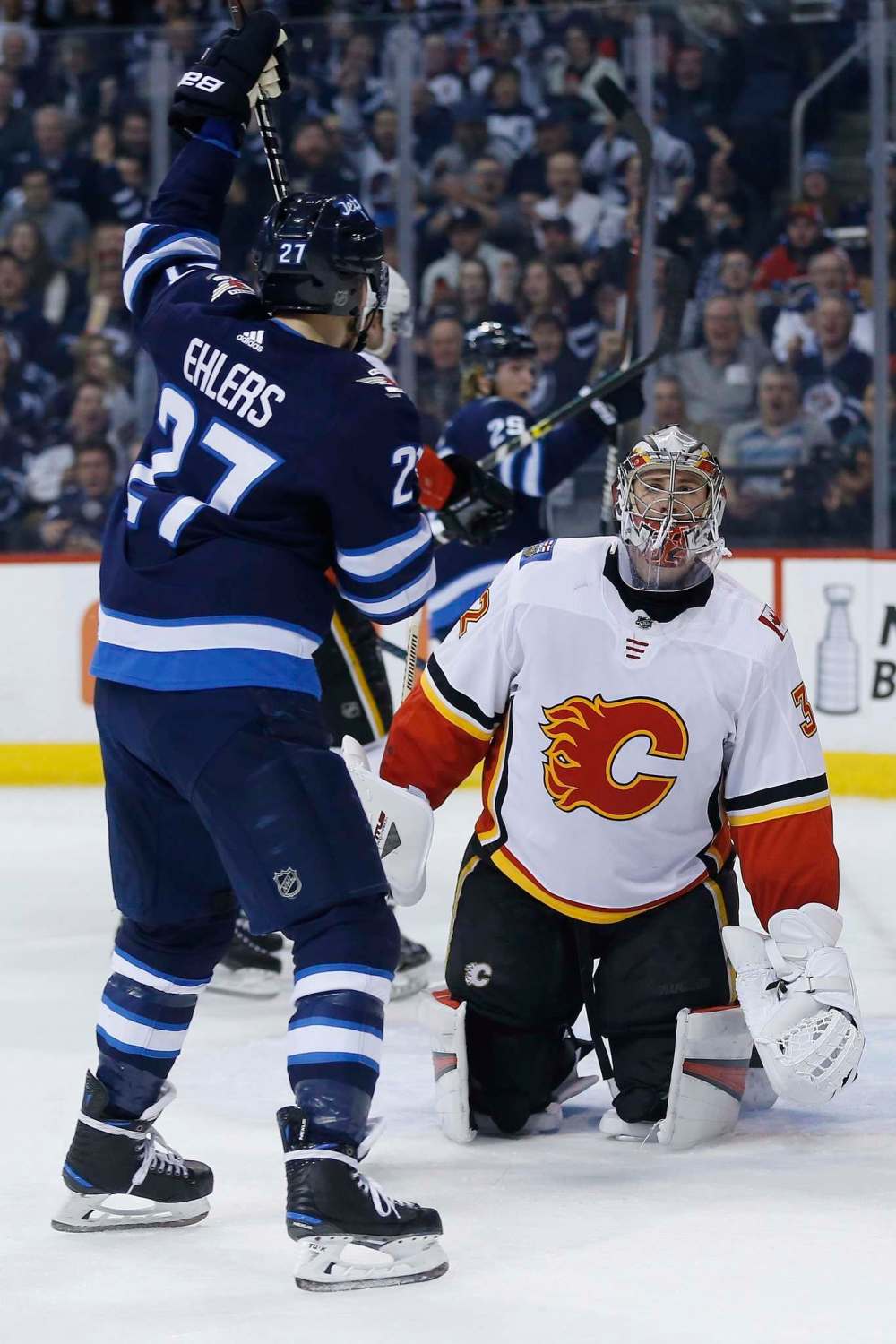THE CANADIAN PRESS/John Woods
Calgary Flames goaltender Jon Gillies reacts as Winnipeg Jets' Nikolaj Ehlers celebrates a goal by teammate Paul Stastny, not shown, during the second period Thursday.