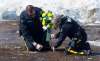 Jonathan Hayward
/ The Canadian Press
Members of the RCMP lay flowers at the intersection of a crash site near Tisdale, Sask., Sunday, April, 8, 2018. A bus carrying the Humboldt Broncos hockey team crashed into a truck en route to Nipawin for a game Friday night killing 15 and sending over a dozen more to the hospital.