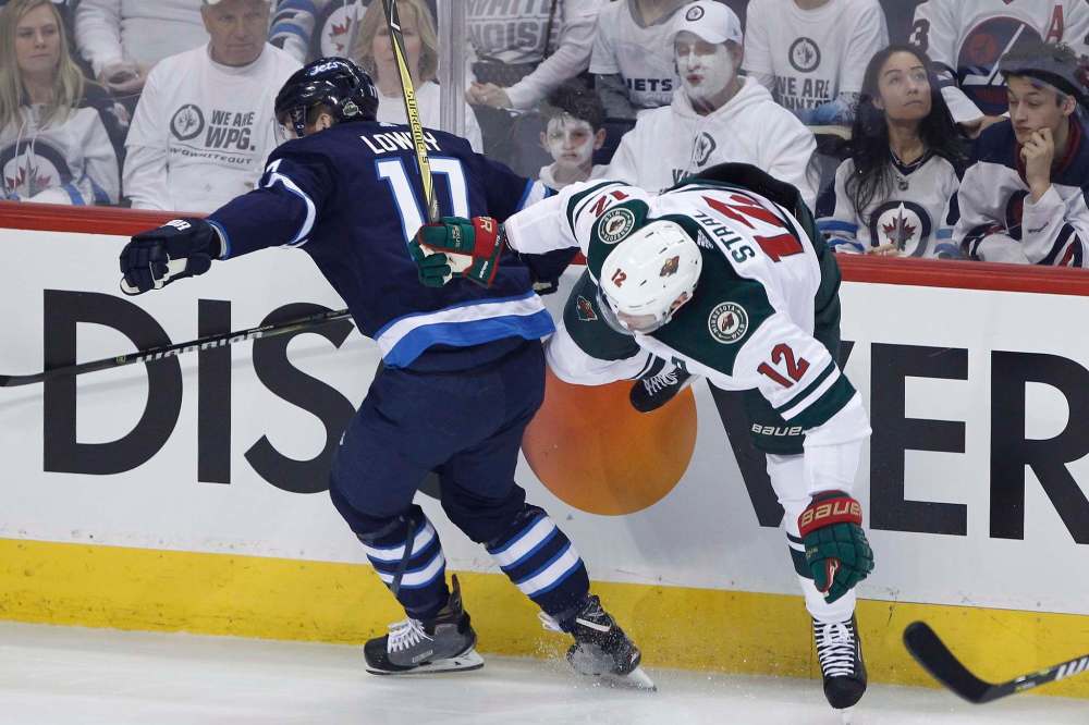 John Woods / The Canadian Press
Winnipeg Jets' Adam Lowry and Minnesota Wild's Eric Staal collide during first period of NHL game one playoff action in Winnipeg on Wednesday.