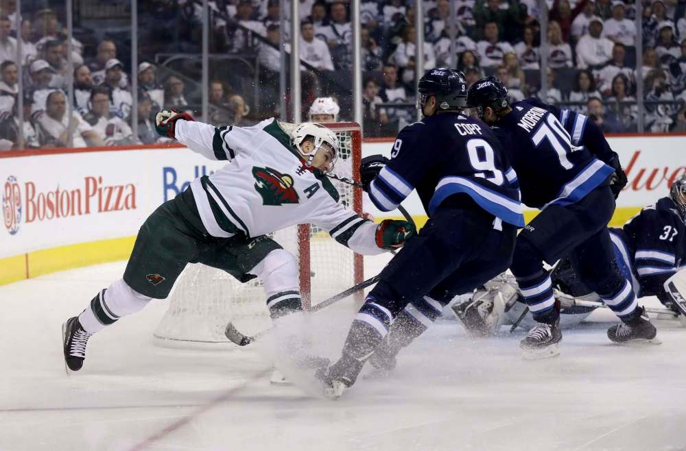 Zach Parise (11) scores on Connor Hellebuyck Wednesday night. (Trevor Hagan / Free Press files)