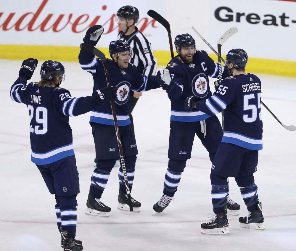 TREVOR HAGAN / WINNIPEG FREE PRESS
Patrik Laine, Paul Stastny, Blake Wheeler and Mark Scheifele celebrate Sheifele's power play goal against the Minnesota Wild in the second period of game one, Wednesday. Scheifele's goal was the result of a gap in coverage caused when the Wild were cheating over towards Laine leaving Scheifele wide open in the slot giving him time to bury a Blake Wheeler pass.