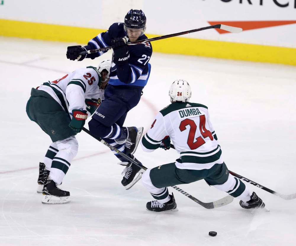 TREVOR HAGAN / WINNIPEG FREE PRESS
Winnipeg Jets' Nikolaj Ehlers narrowly avoids a hit by Minnesota Wild's Jonas Brodin and Matt Dumba during second period, Wednesday.