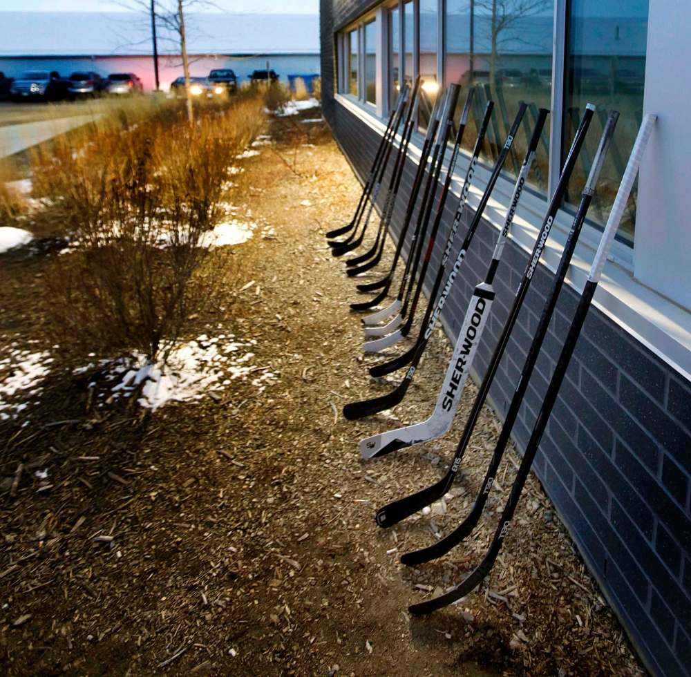 Sixteen hockey sticks are lined up outside Virden’s Tundra Oil & Gas Place Thursday. (Phil Hossack / Winnipeg Free Press)