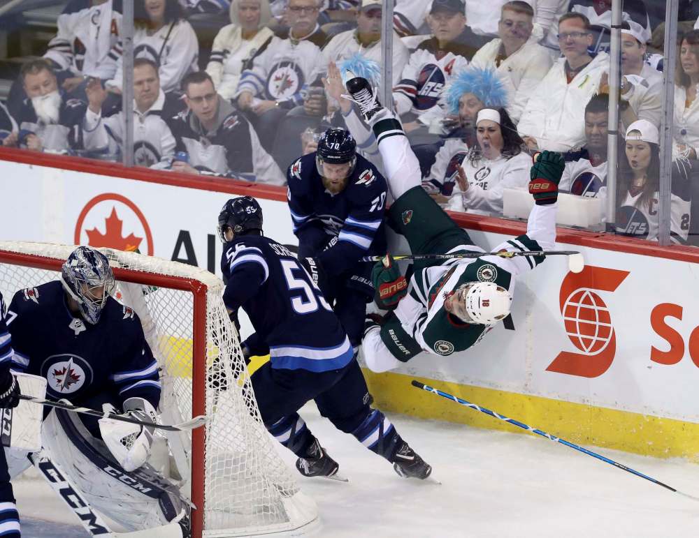 TREVOR HAGAN / WINNIPEG FREE PRESS
Winnipeg Jets' Joe Morrow crushes Minnesota Wild Jordan Greenway during second period, Friday.
