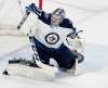 (Carlos Gonzalez/Minneapolis Star Tribune/TNS)
Winnipeg Jets goalie Connor Hellebuyck, top, makes a save in Game 4 Tuesday.