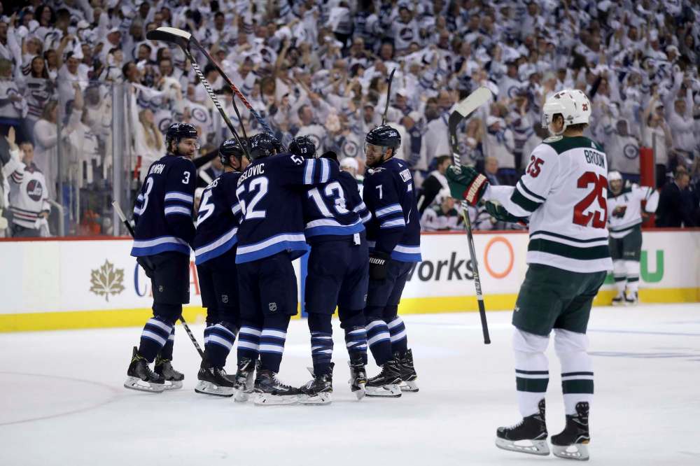 TREVOR HAGAN / WINNIPEG FREE PRESS The Winnipeg Jets' celebrate after Brandon Tanev (13) scored on Minnesota Wild's goaltender Devan Dubnyk (40) during first action in game 5 of their playoff series, Friday, April 20, 2018.