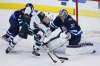 Minnesota Wild's Jordan Greenway (18) can't get the puck past Winnipeg Jets goaltender Connor Hellebuyck (37) during first period game five NHL playoff action in Winnipeg on Friday, April 20, 2018. THE CANADIAN PRESS/John Woods